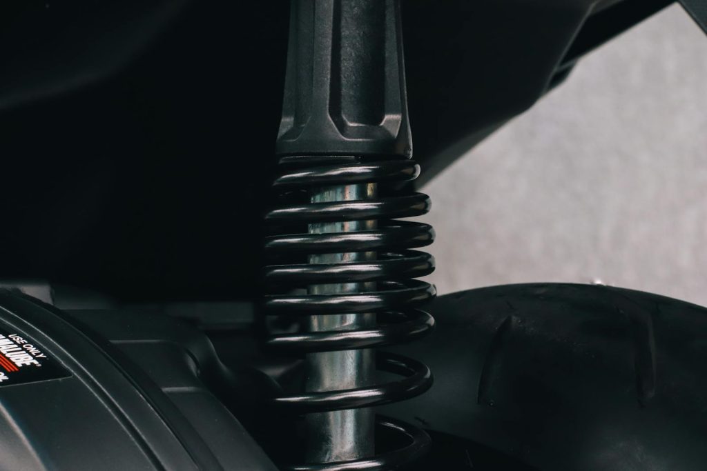 Detailed view of a motorcycle's suspension spring and metal components
